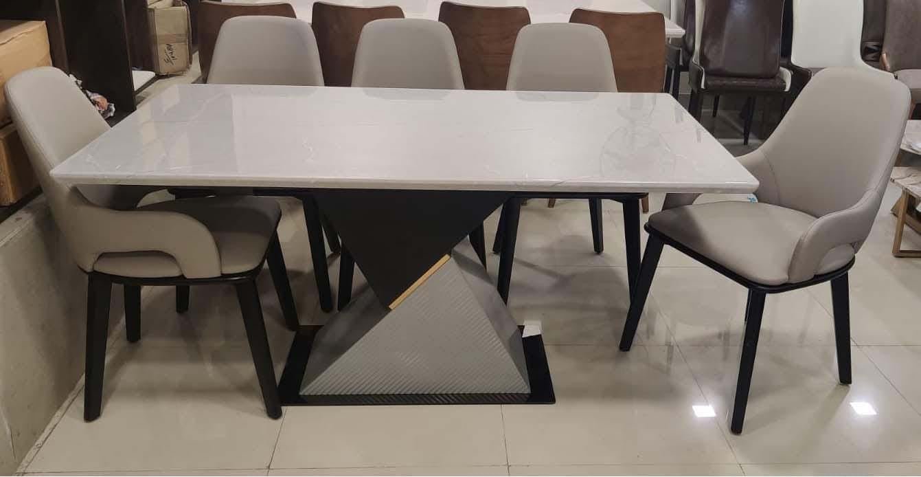 "Modern Dining Set with Sleek White Marble Top and Geometric Base Design"